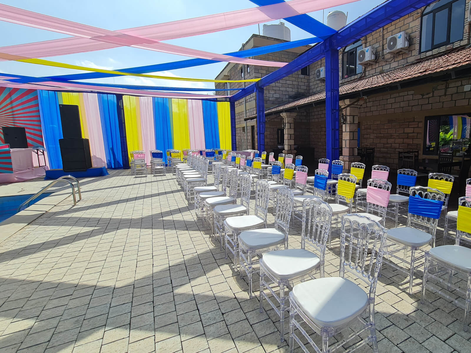 Outdoor event setup with colorful decorations and seating arrangement, perfect for wedding decoration, event planning, and sangeet ceremonies.