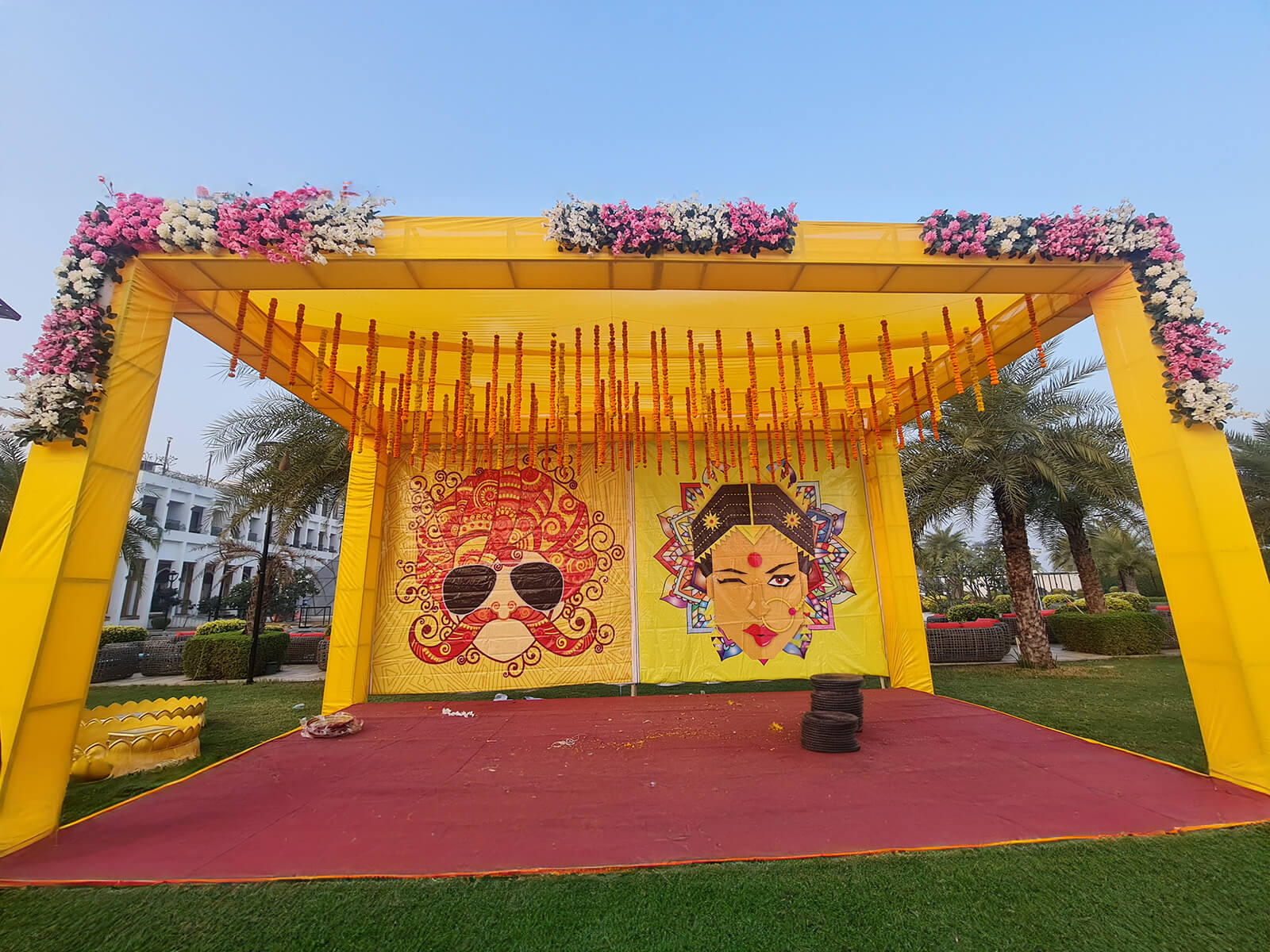 Outdoor haldi ceremony stage with vibrant yellow and floral decorations, ideal for event planning, wedding decoration, and destination weddings.