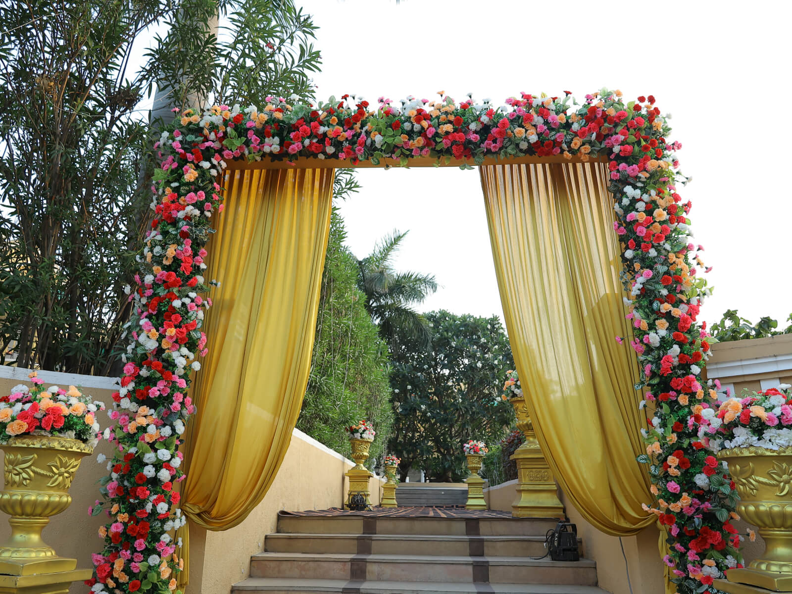 Indoor wedding reception with lavish decor and stage setup