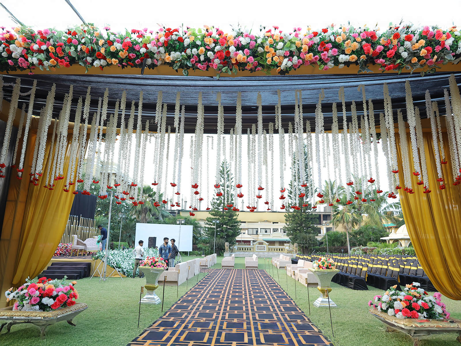 Outdoor wedding reception with string lights and floral decorations