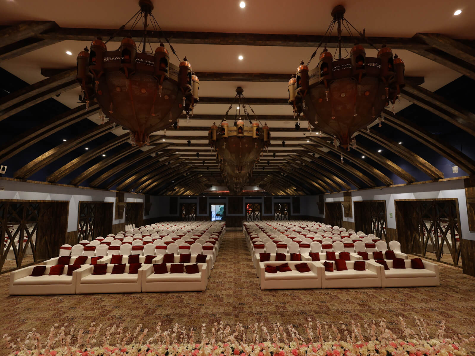 Indoor wedding event hall with elegant seating arrangement and stage setup, perfect for wedding decoration, event planning, and sangeet ceremonies.