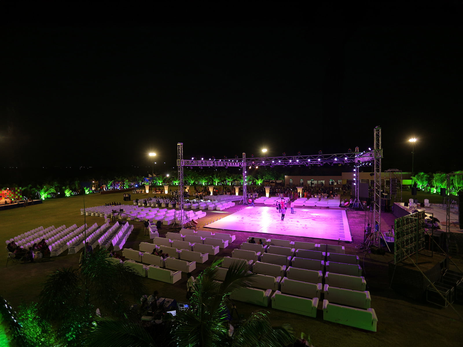 Outdoor event stage setup with musical instruments and illuminated backdrop, ideal for sangeet ceremonies, event planning, and wedding decoration.