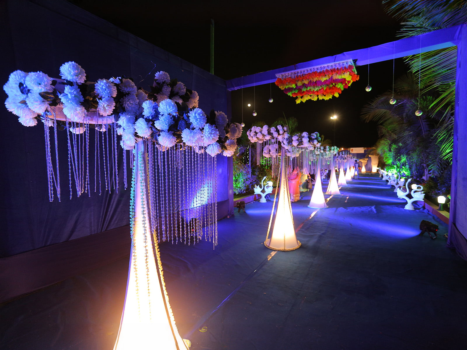 Outdoor wedding event with elegant floral decorations and swan sculptures, ideal for wedding decoration, event planning, and destination weddings.