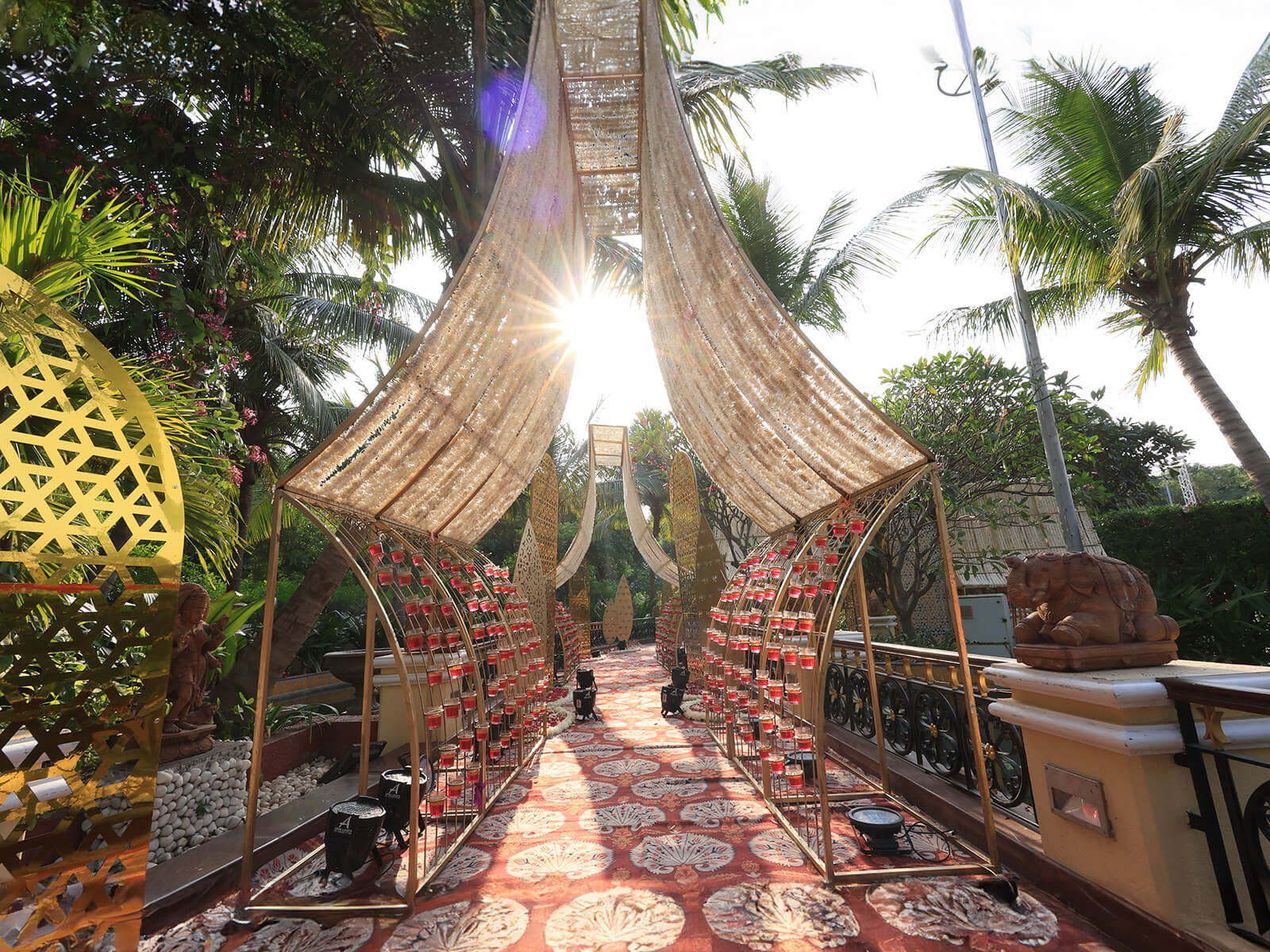 Outdoor wedding event decoration with elegant canopy, floral arrangements, and intricate patterns, ideal for destination weddings and event planning