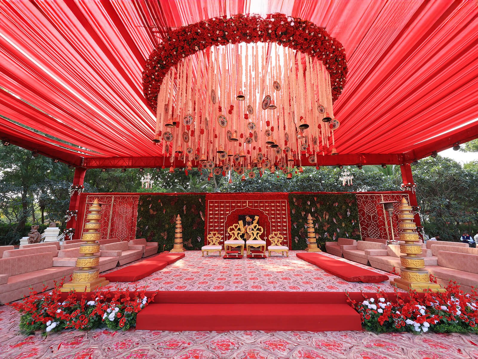 Outdoor wedding event decoration with intricate floral arrangements, elegant canopy, and traditional elements, perfect for destination weddings and event planning.